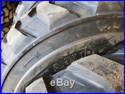 (4- Tires with Wheels) New Holland LS skid-steer tire size 14-17.5 14175