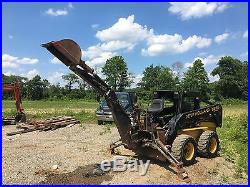 New Holland skid steer LX865 with backhoe attachment New Holland B-104
